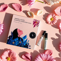 “Awawa Luxury Scented Symphony Duo gift box with Bloomé and Fleuréa vials on pink backdrop with flowers”