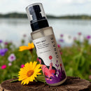 Awawa Luxury ornate body mist bottle with floral design placed on wooden surface near yellow flower outdoors